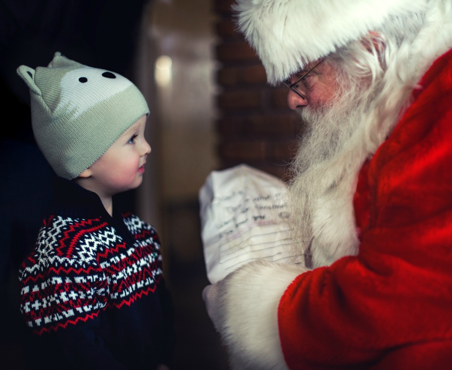 Santa with young boy and his christmas list