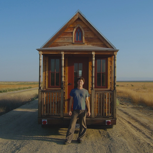 Tiny House with Person Standing in front