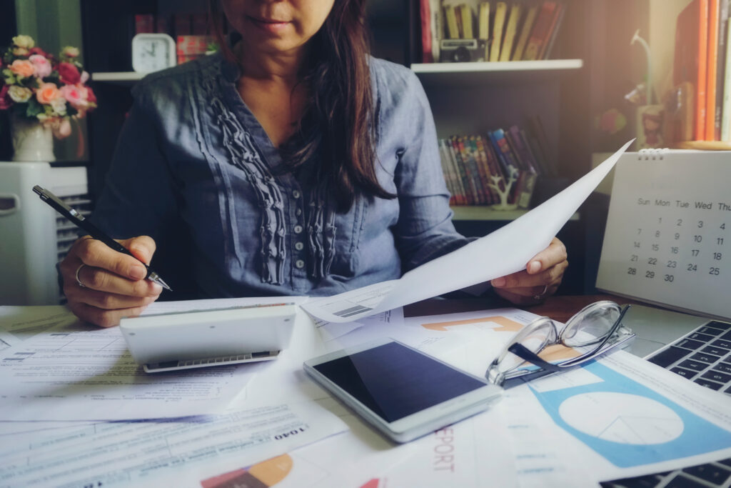 Woman planning a budget and calculating taxes 