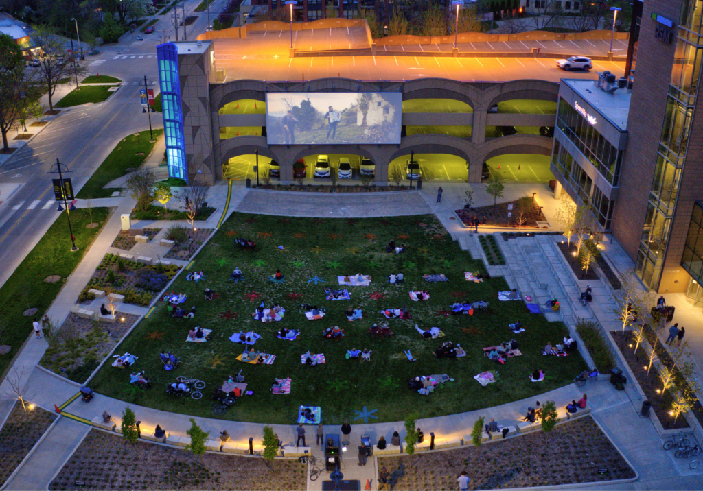 People watching an outdoor movie at Film Scene in the Park in Iowa City