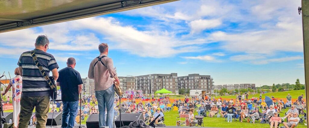 Musician playing on stage during Rhythms at Riverfront Crossing in Iowa City