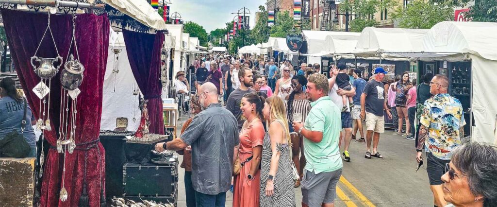Shoppers browsing at one of the top Iowa City summer events, the Iowa Arts Festival