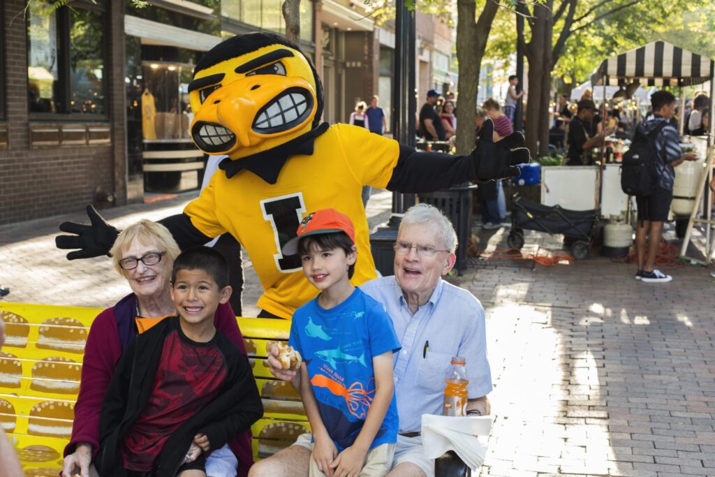 Children posing with grandparents and Herky during Taste of Iowa City