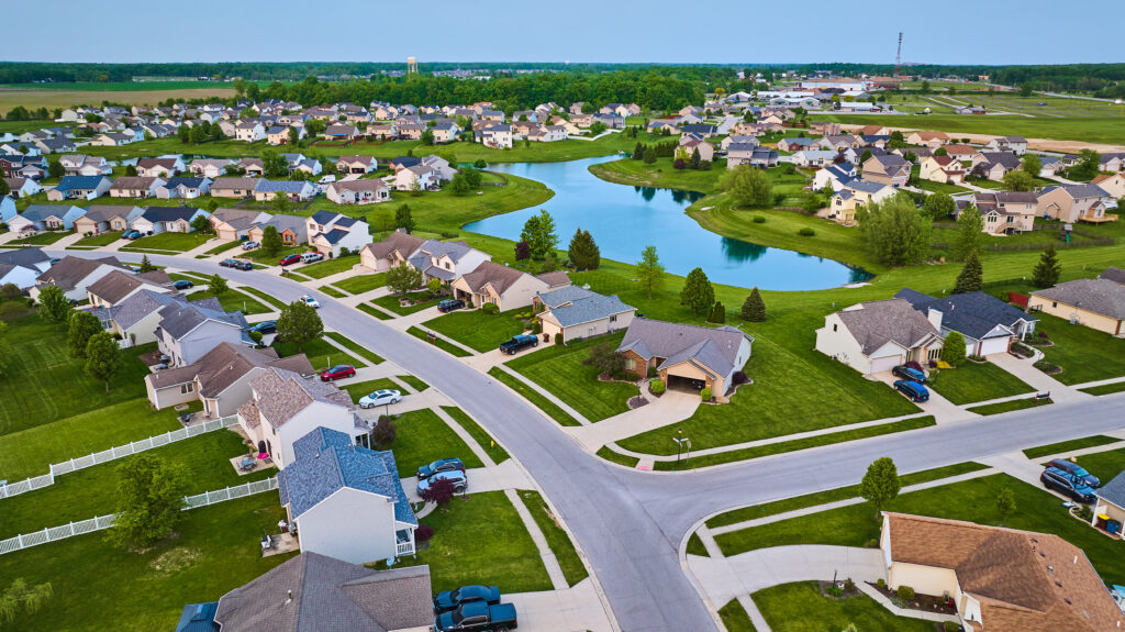 Large pond surrounded by a suburban neighborhood HOA