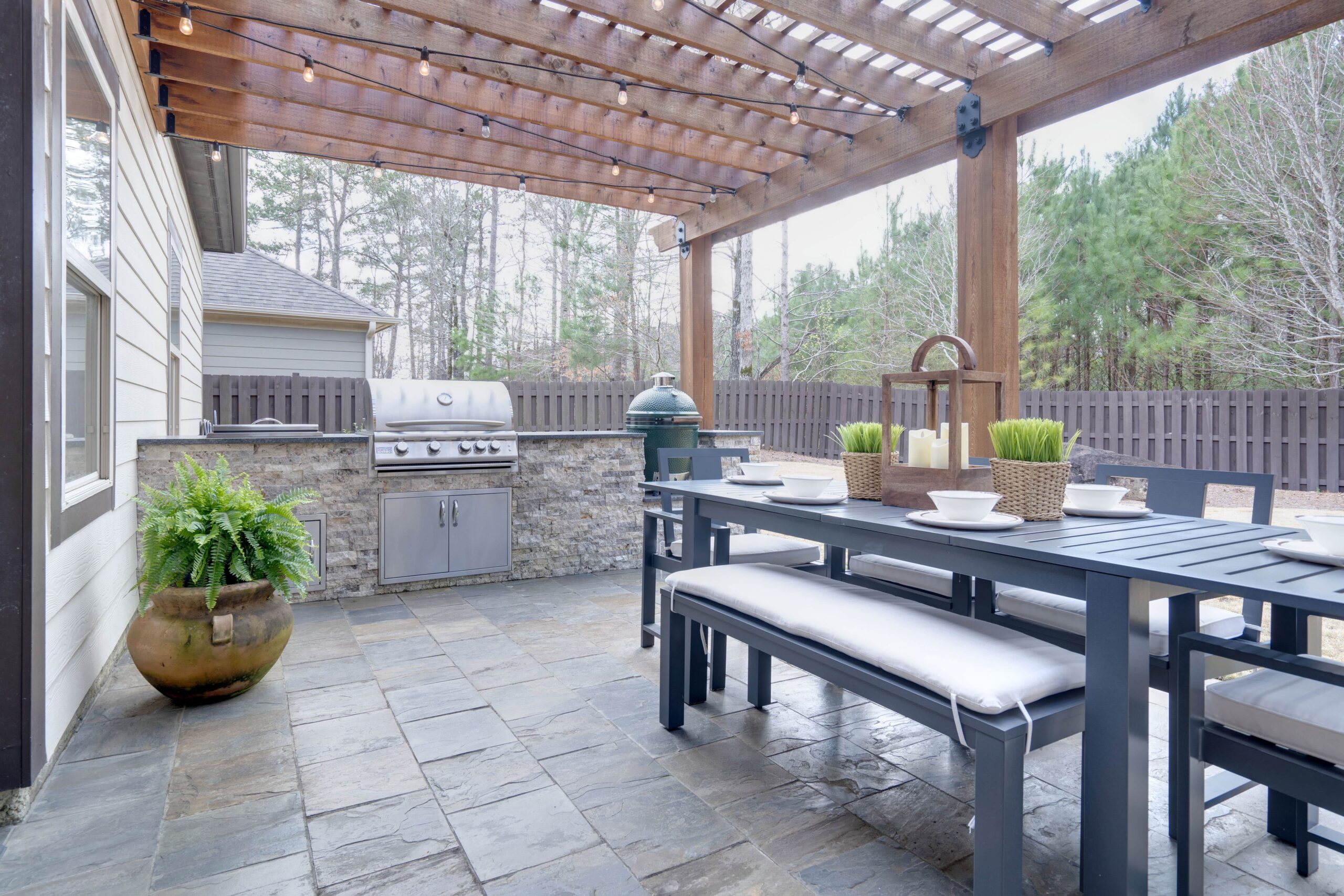 Beautiful outdoor kitchen with table set and grilling station