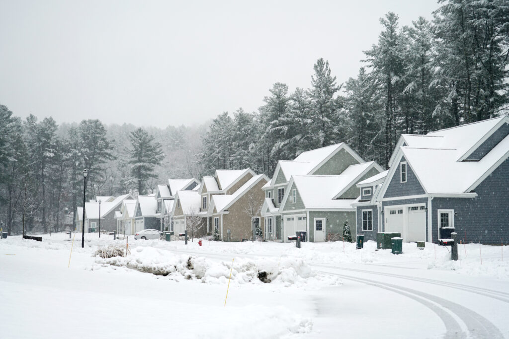 Houses in a residential neighborhood during snowfall in the winter