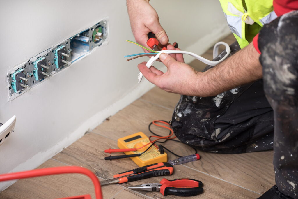 Hands of electrician doing electrical work