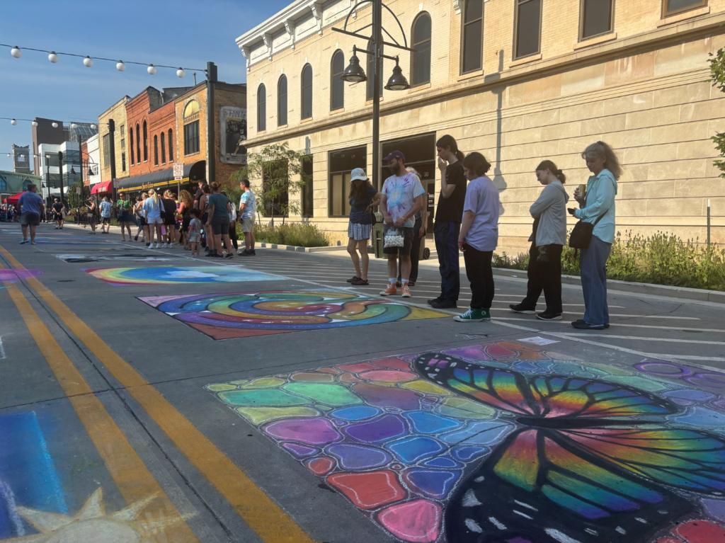 People admiring chalk art in downtown Iowa City during Chalk the Walk