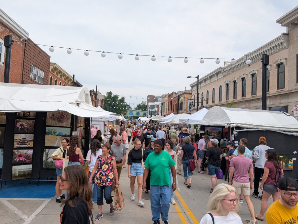 People walking through the Iowa Arts Festival in downtown Iowa City