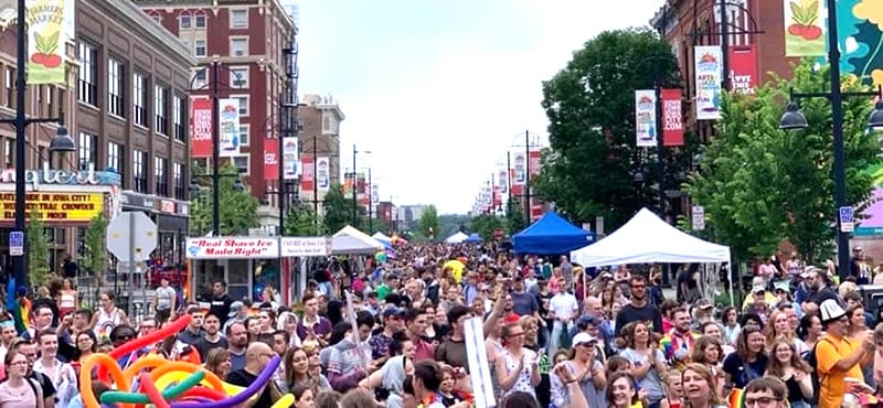 People celebrating in the streets at the Iowa City Pride Festival