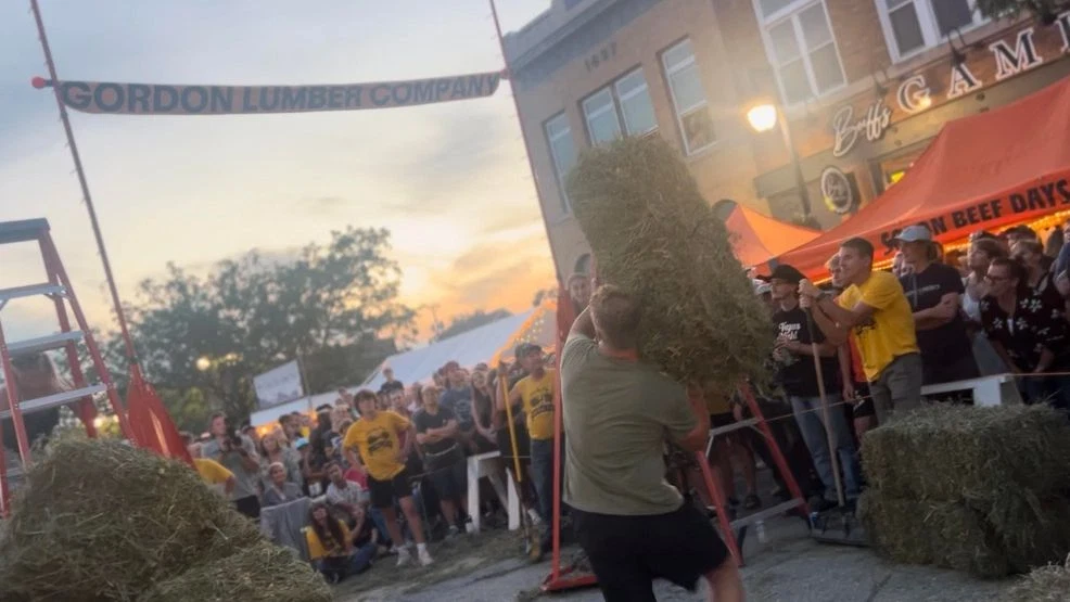 Man throwing a hay bale during the Solon Beef Days Hay Bale Toss in Solon, Iowa