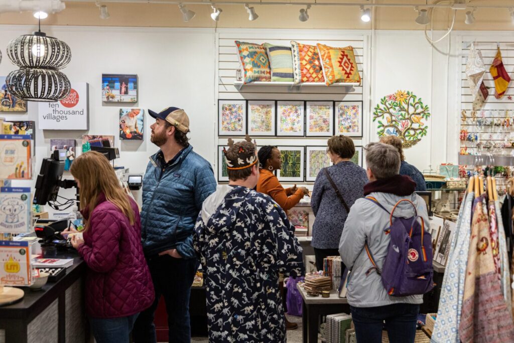 People browsing in a shop during the Summer Gallery Walk in Iowa City, Iowa