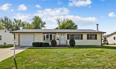 Front of home, tandem garage with drive thru to the fenced backyard.