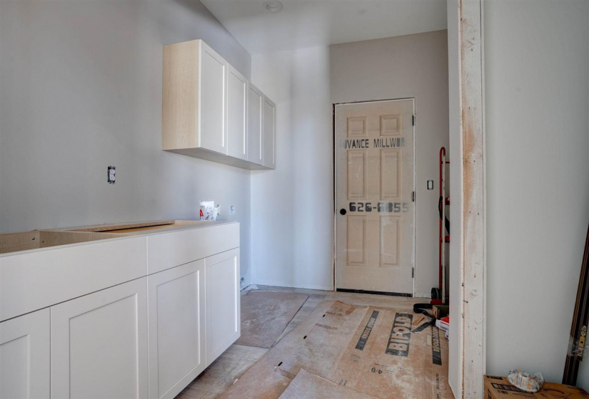 Cabinetry, sink, built-in lockers and coat closet.