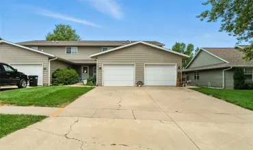 End driveway with a sideyard and private yard on the side and back    This attached condo feel like a stand alone with its larger than most wrap around deck, and back yard